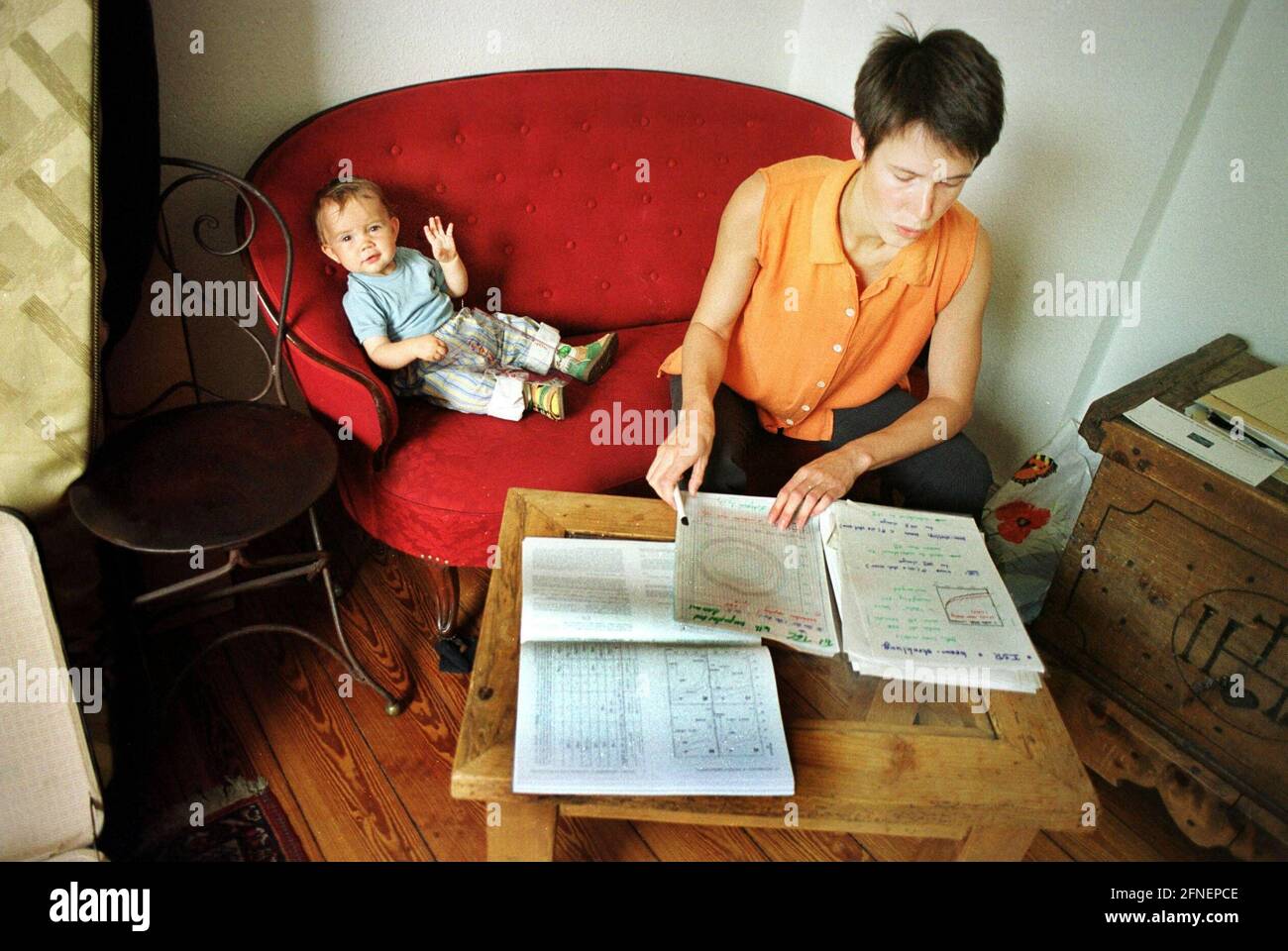 SILKE PETZOLD, prospective professor, currently in London with her husband and child, here still in her Hamburg flat doing scientific work. July 1999 [automated translation] Stock Photo
