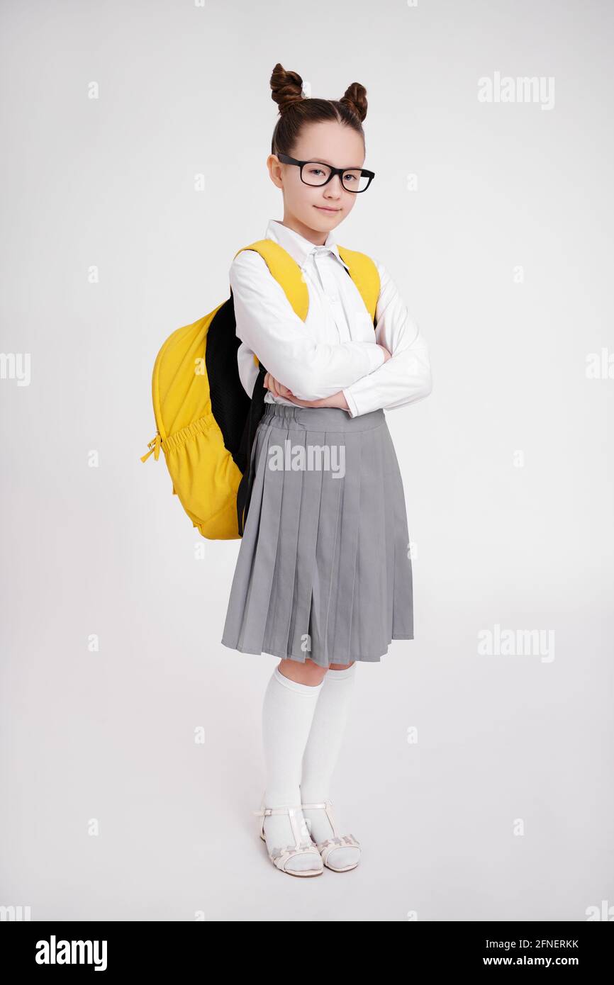 full length portrait of cute preteen girl in school uniform and