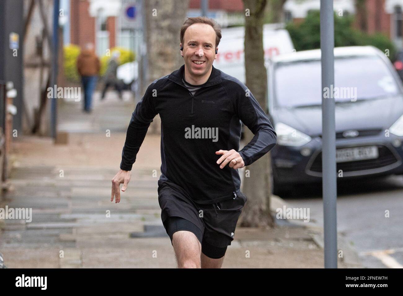 Health Secretary Matt Hancock is seen smiling as he leaves his West London home for a jog, on the 17th of May 2021, as the Lockdown rules in England, Stock Photo