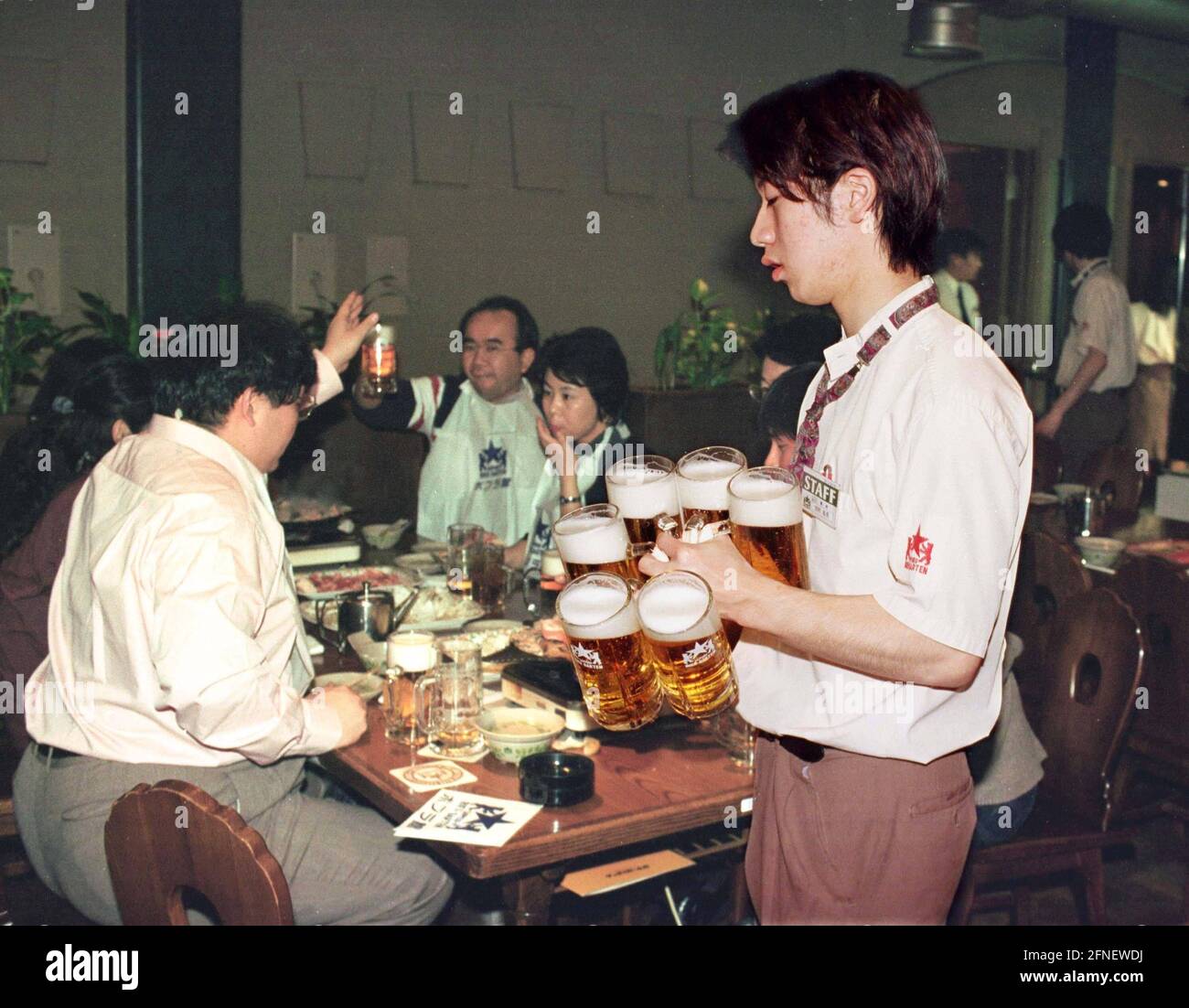 A waiter serving at the Sapporo Beer Garden. [automated translation