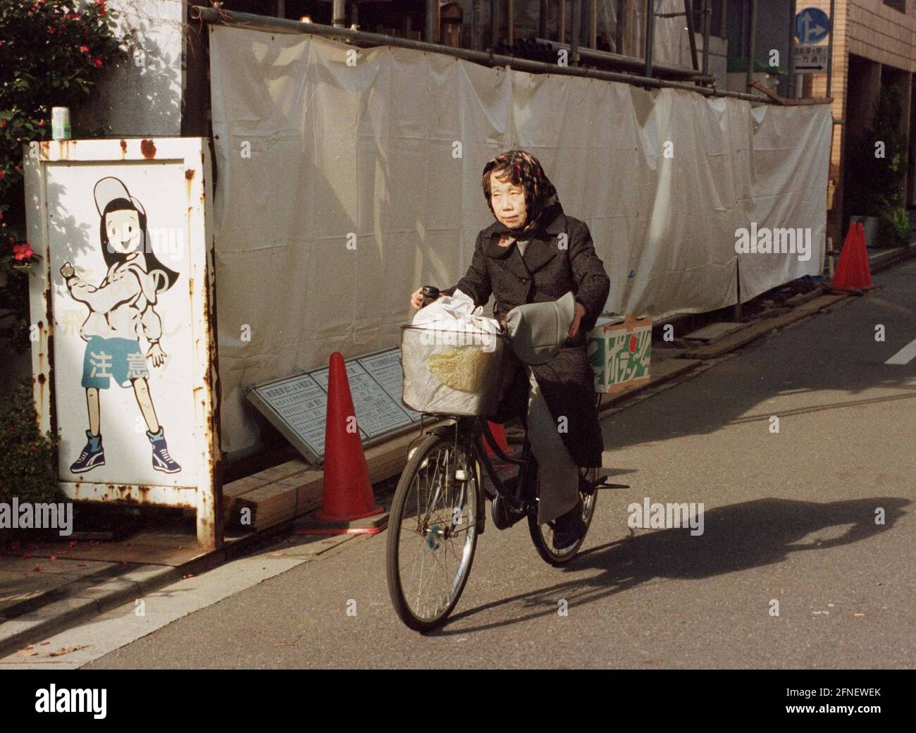 Woman On Bicycle In Tokyo Automated Translation Stock Photo Alamy