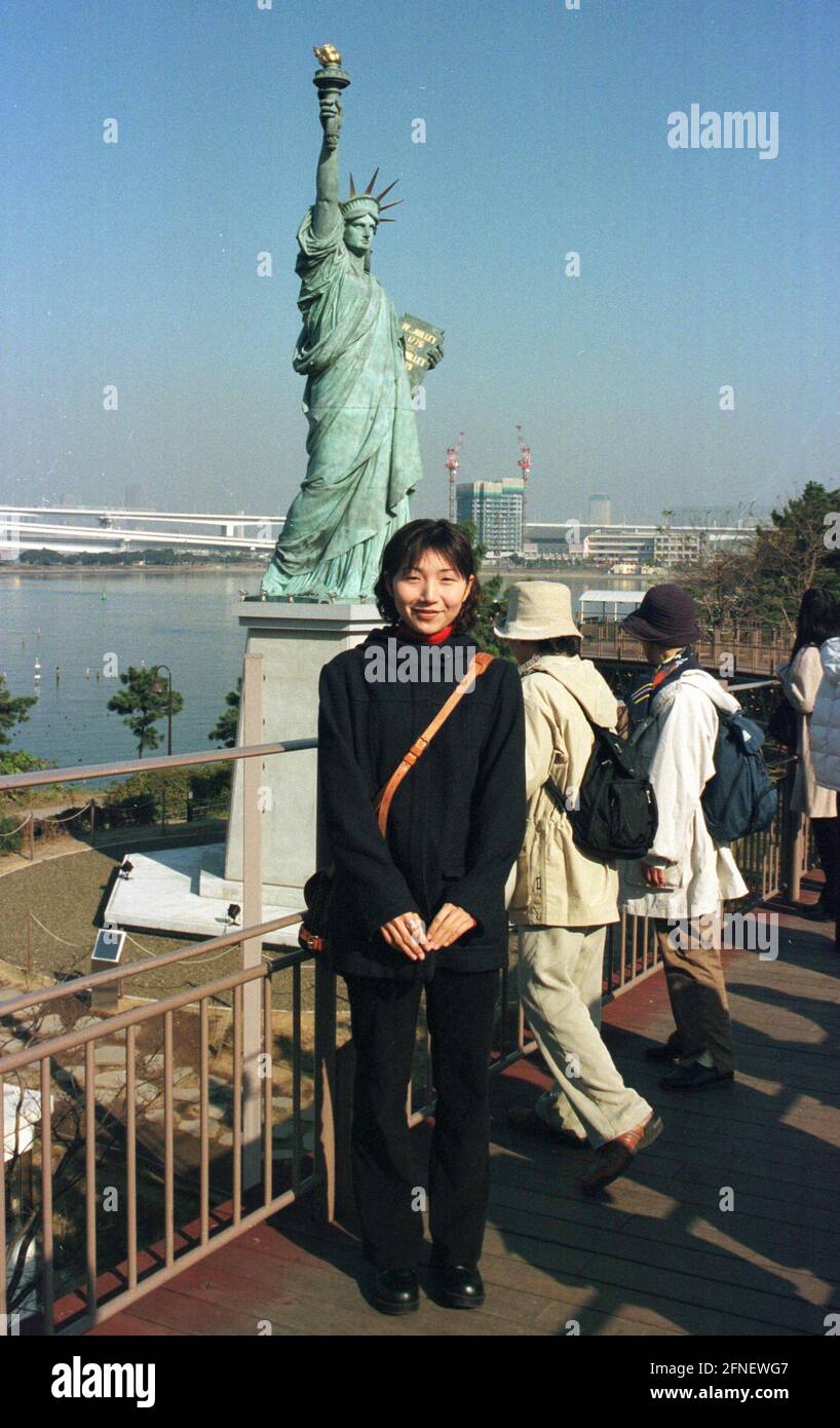 Japanese woman in front of the Statue of Liberty on the artificial