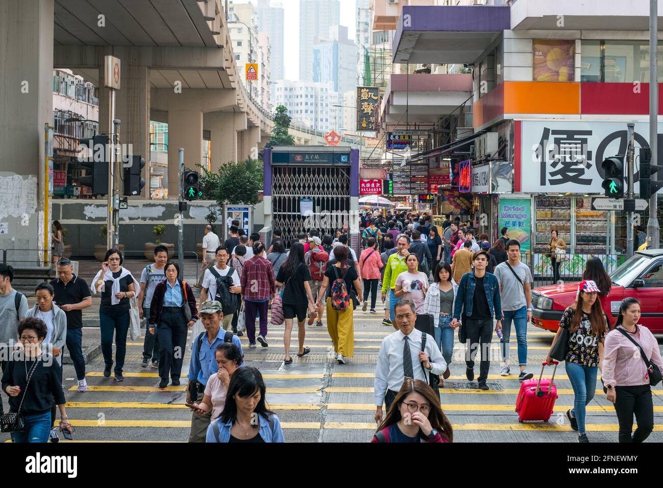 Hong Kong - November, 2019: Crowd of walking people crossing street in Hong Kong Stock Photo