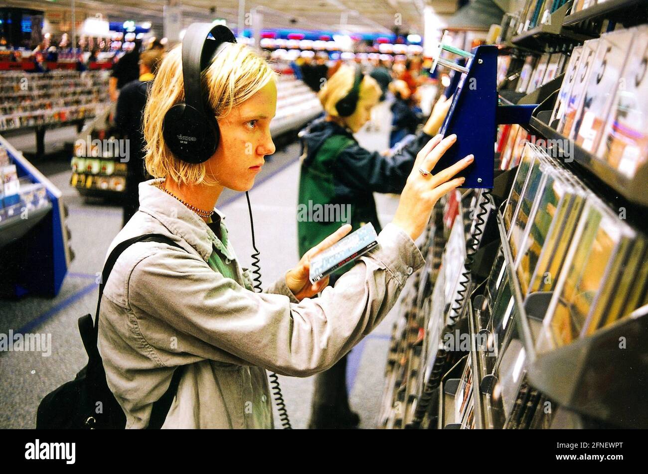 Young people picking out CDs in Munich (Saturn-Hansa) [automated translation] Stock Photo