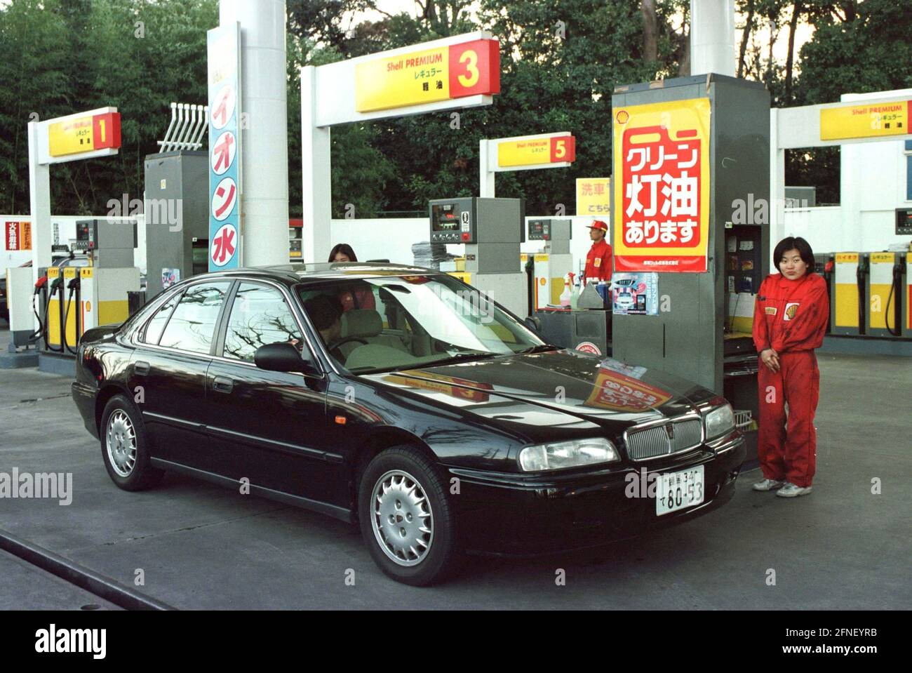 Car filling up at a gas station. [automated translation] Stock Photo