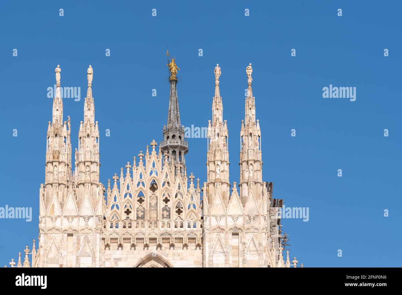 Details of Duomo with the golden statue name "Madonnina" on the top of