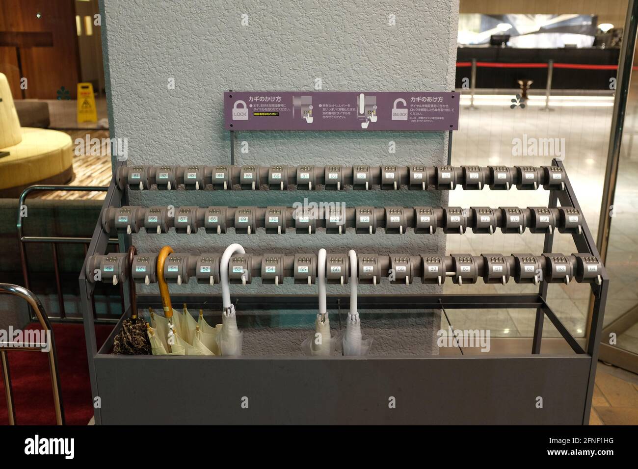 An umbrella holder with code locks in Tokyo, Japan Stock Photo Alamy