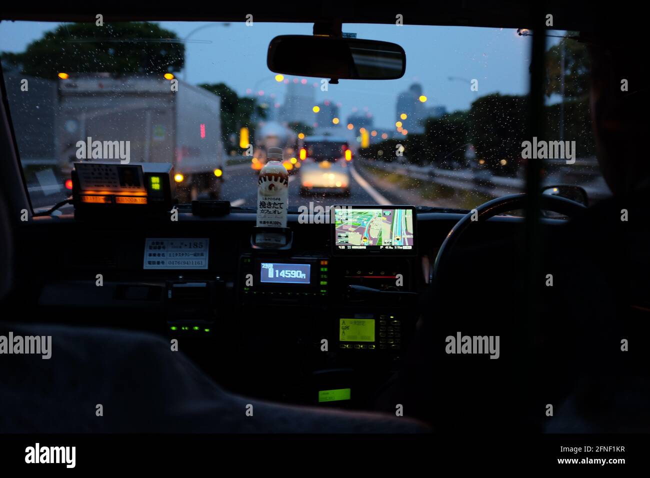 A view of the dashboard of a taxi driving on the highway in Tokyo 