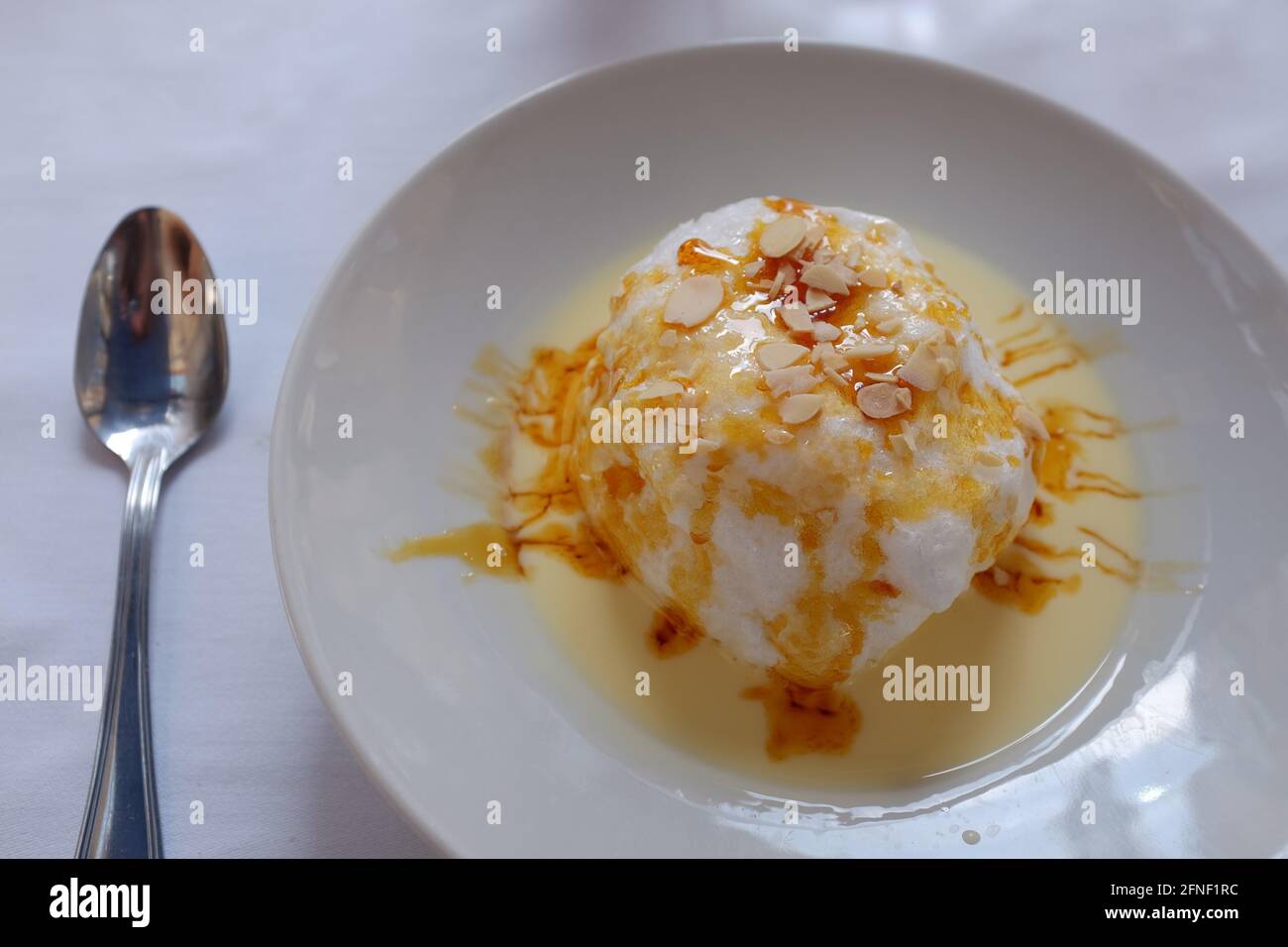Floating Island dessert, egg white on English cream, in Toulouse, Haute-Garonne, Occitanie, South of France Stock Photo