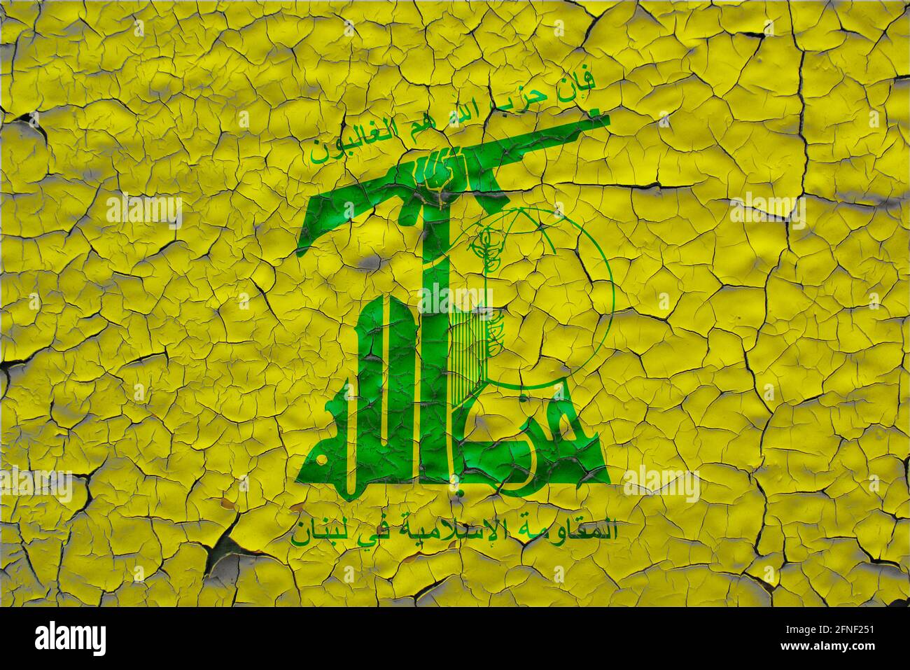Hezbollah flags painted over cracked concrete wall Stock Photo