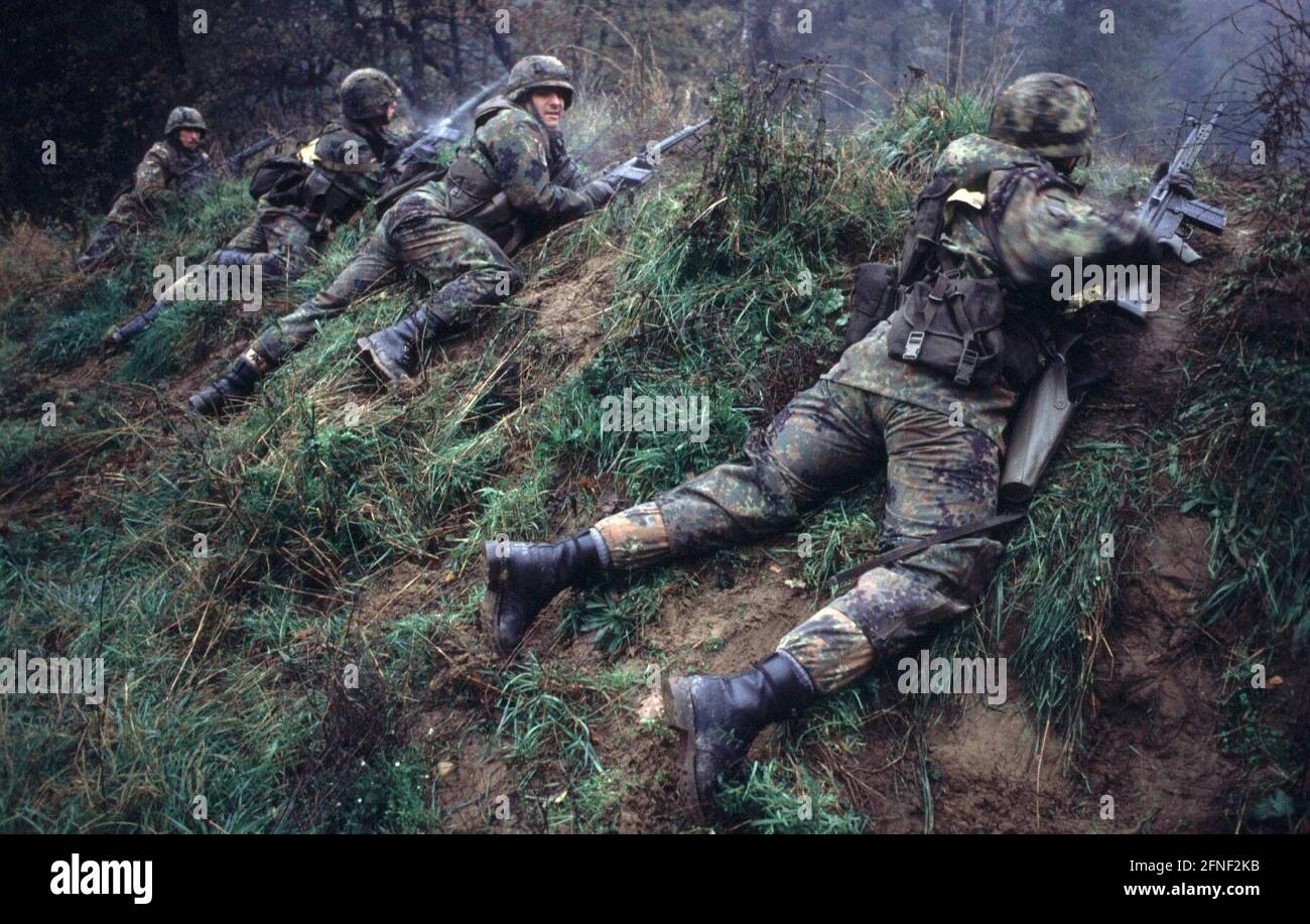 Soldiers of the Bundeswehr lie in a trench slope during their training. [automated translation] Stock Photo