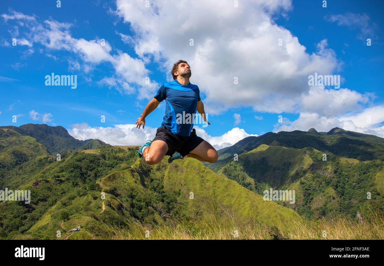 Trekker flying on natural mountain landscape. Funny concept photo. Tourist travels through the mountains. Photos of holidays in beautiful places. Trac Stock Photo