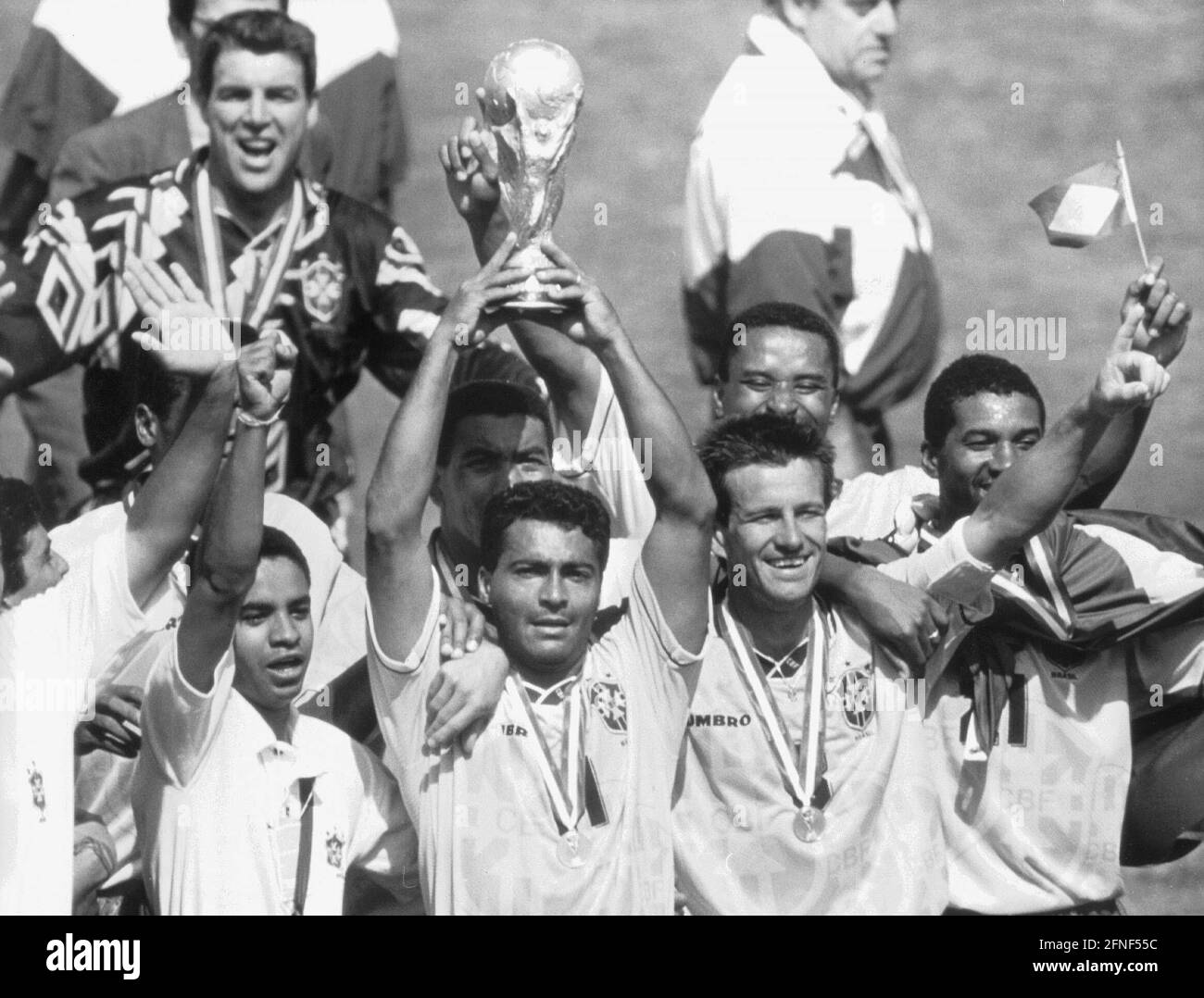 Brazil become world champions for the fourth time after beating Italy 3 : 2 on penalties in the final. Brazil's star striker Romario with the World Cup trophy, Dunga on the right. [automated translation] Stock Photo