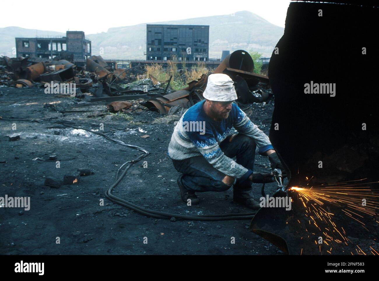 'Workers on the factory site dismantling the factory ''Carbosin S.A.'' in the village of Copsa Mica. Here the factory ''Carbosin'' polluted the surroundings and the village with soot. Since January 1994 the factory has been closed down.n [automated translation]' Stock Photo