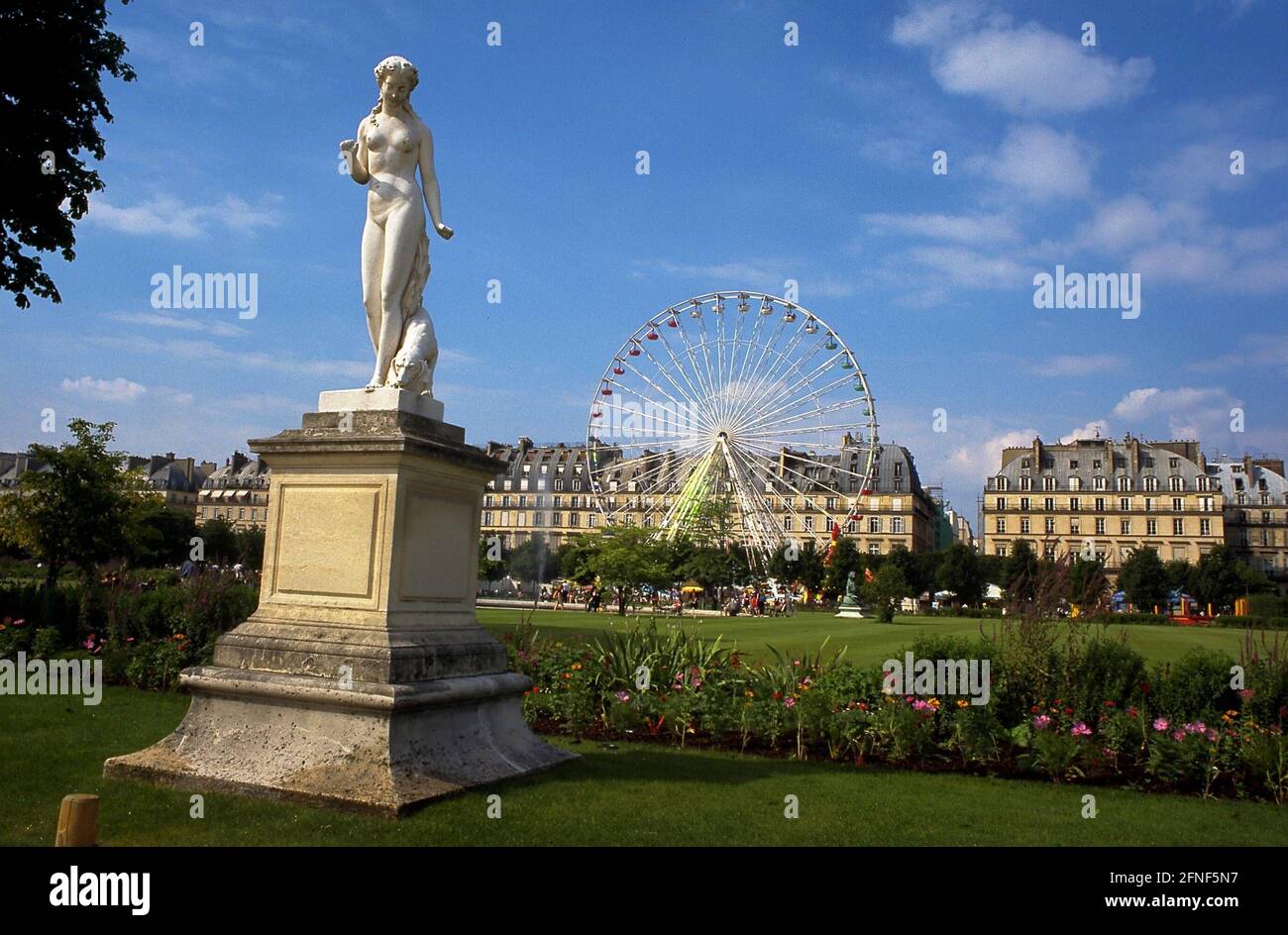A statue and a Ferris wheel in the Jardin des Tuileries in Paris, which