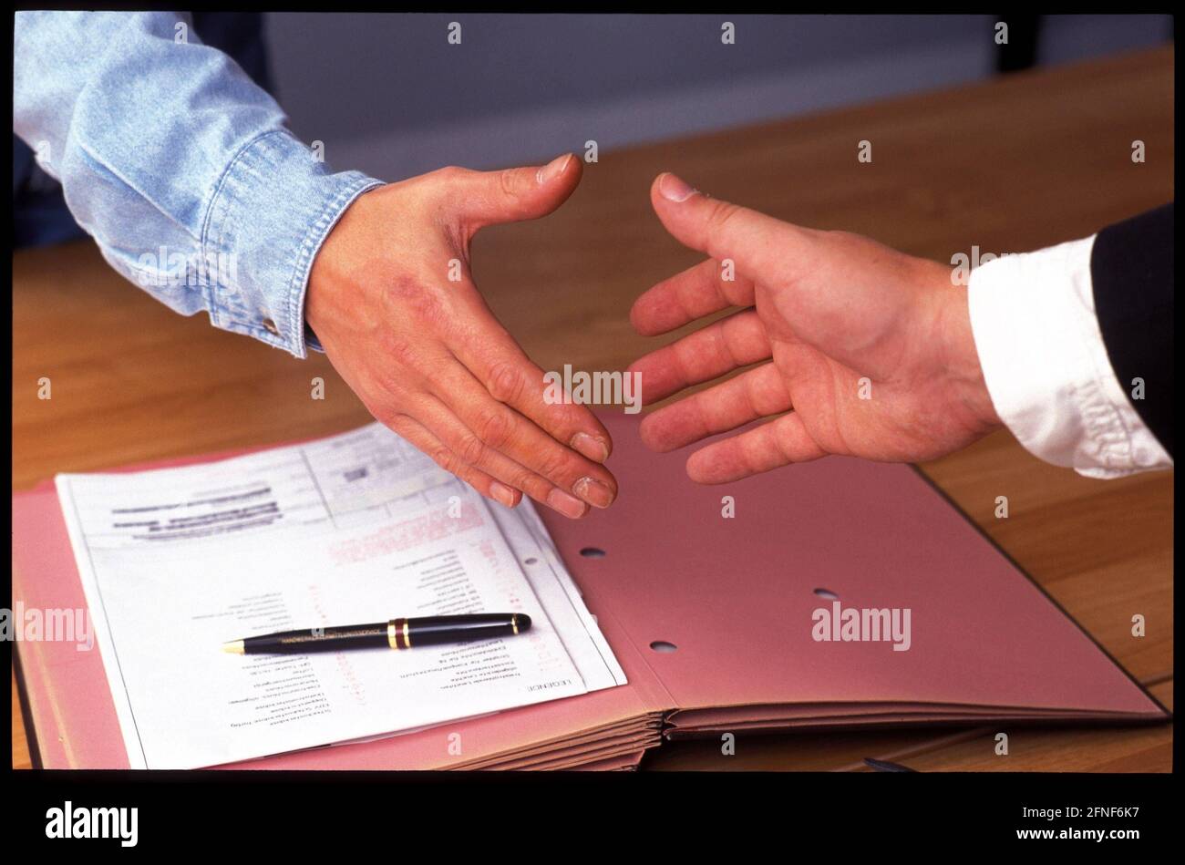 Sealing a contract with a handshake. [automated translation] Stock Photo