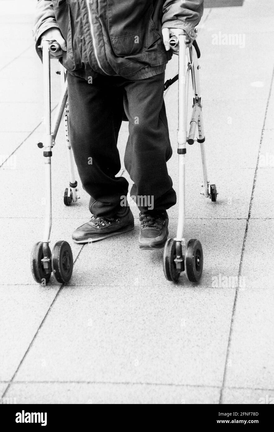 Physically handicapped man with walker. [automated translation] Stock Photo