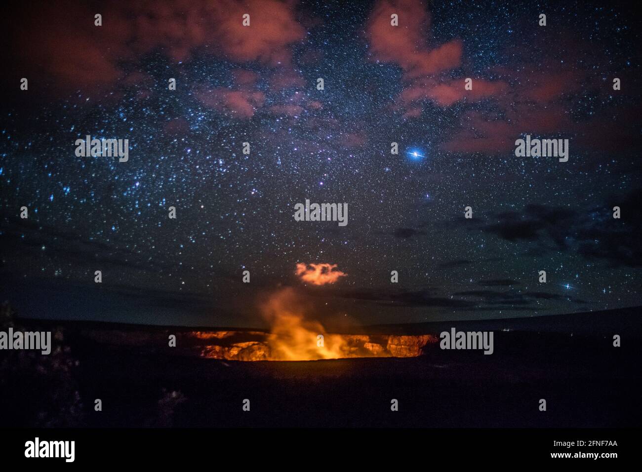The night sky and Glowing steam from lava within the Halemaumau crater within the Kiluaua caldera at Volcanos National Park in the Big Island of Hawai Stock Photo
