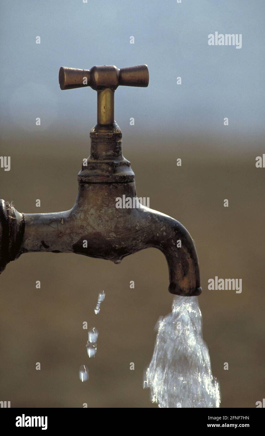 Water flows from an old faucet. [automated translation] Stock Photo