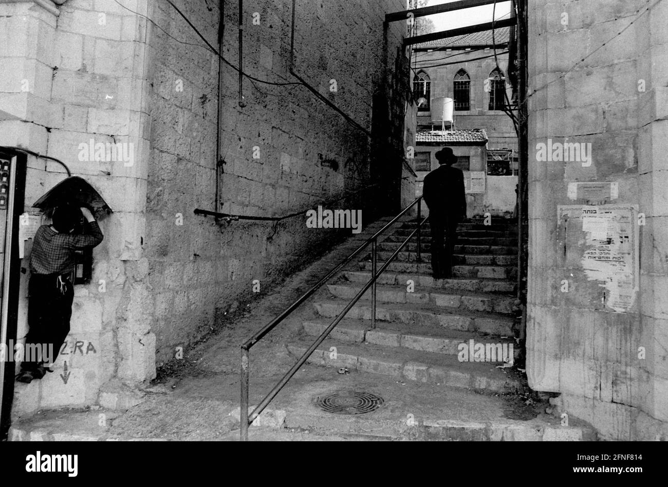 Staircase in the Jerusalem neighborhood of Mea Sharim, inhabited by mostly Orthodox Jews. A young boy steals money from a public telephone. [automated translation] Stock Photo