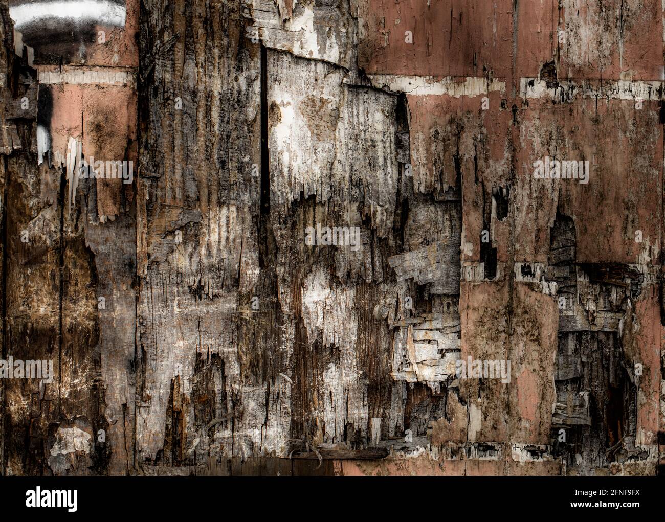 Old weathered and broken wood siding on building in need of repair Stock Photo