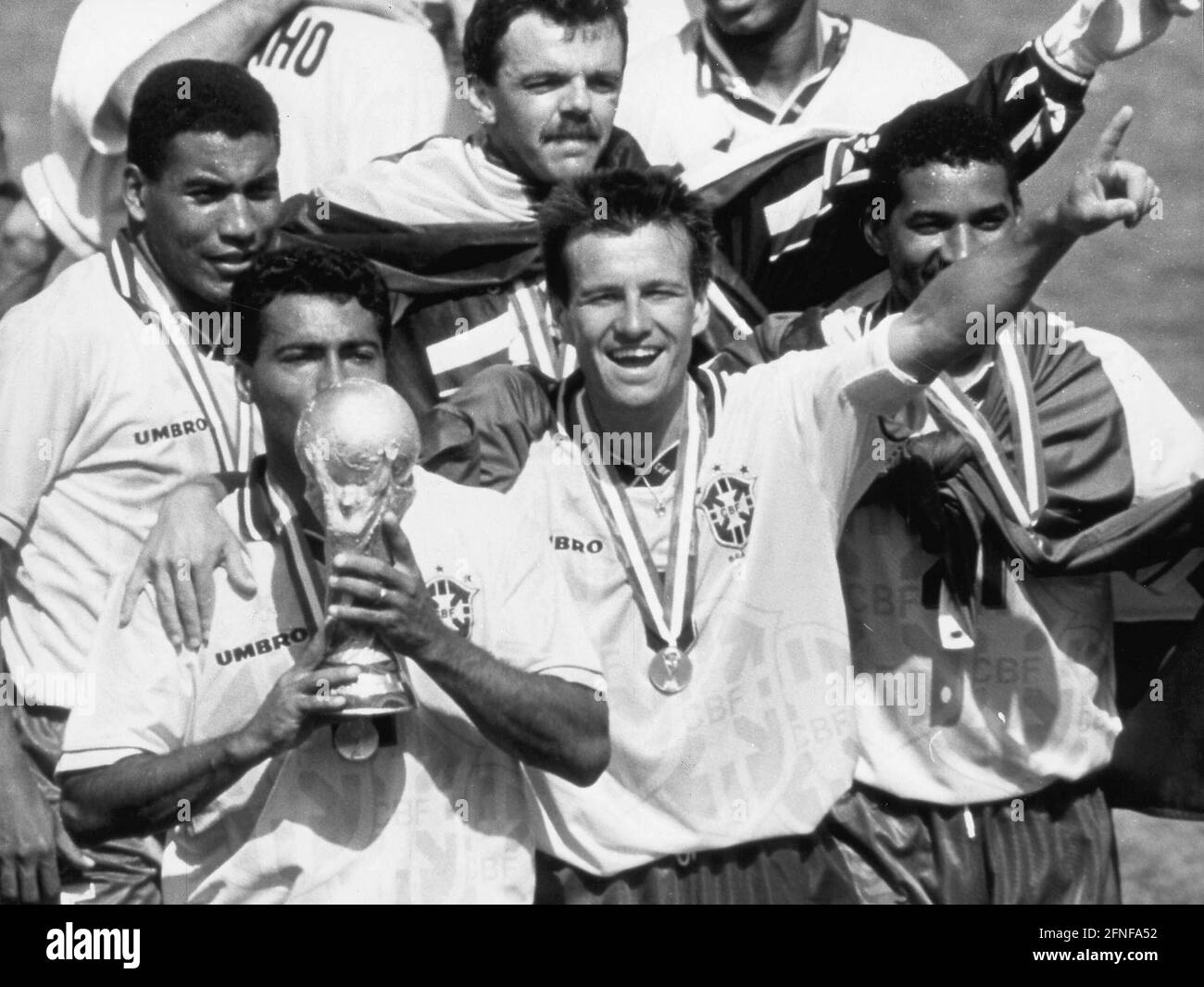 Photo date: 17.07.1994 After the World Cup final, in which Brazil beat Italy 3-2, Brazil's striker Romario kisses the World Cup trophy, Dunga on the right. [automated translation] Stock Photo