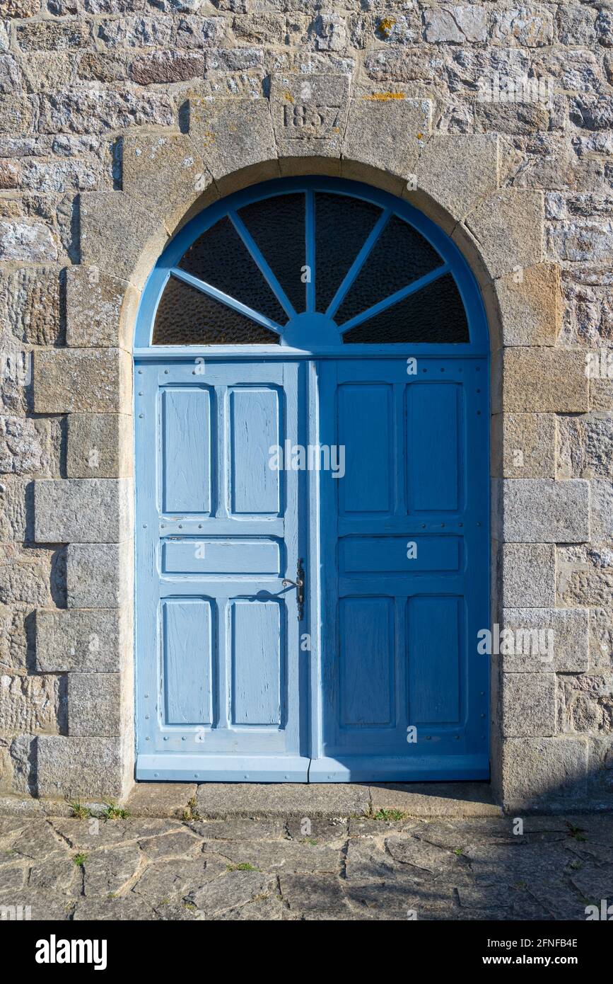 Blue door in old stone fort wall Houat island, France Stock Photo