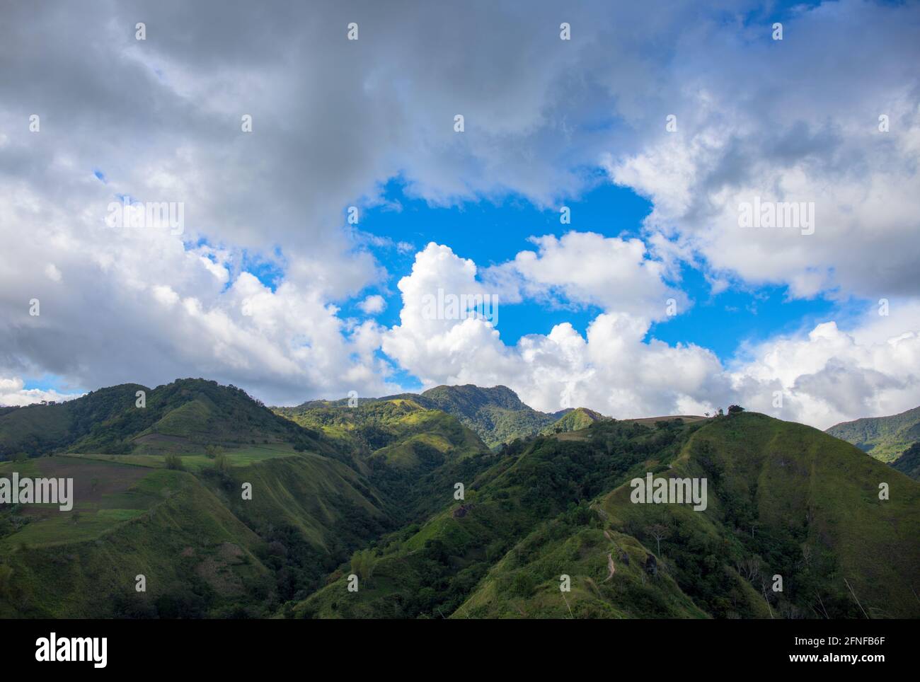 Green mountains panorama under cloudy sky spectacular landscape. Rural land scenery. Summer travel hiking in green hills. Untouched nature parkland. V Stock Photo
