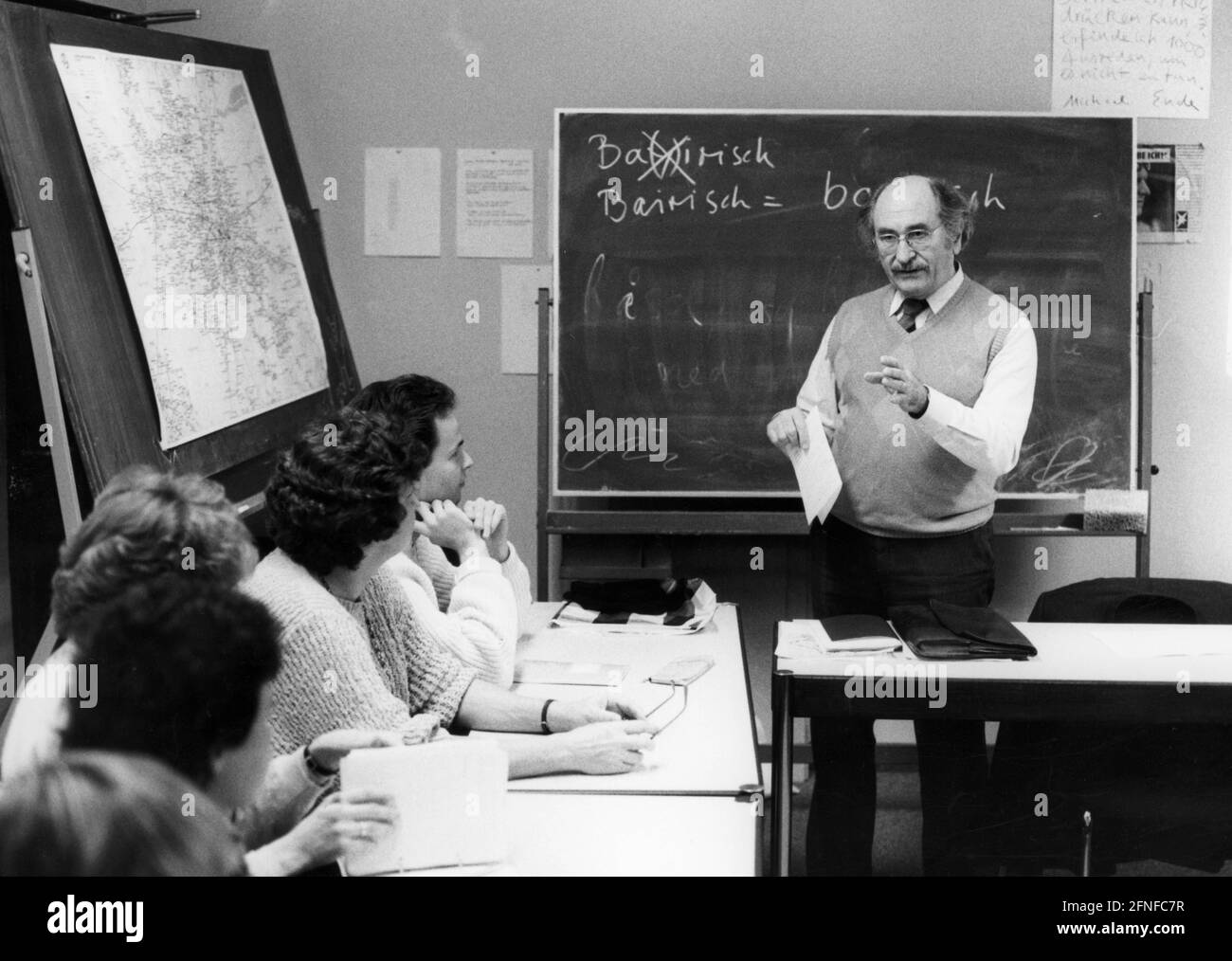 The director of the Goethe-Institut in Munich, Dr. Korbinian Braun is a specialist for the Bavarian language. Here he is giving some students lessons in the Bavarian language. A map of Bavaria hangs on one of the blackboards. Undated photograph. [automated translation] Stock Photo
