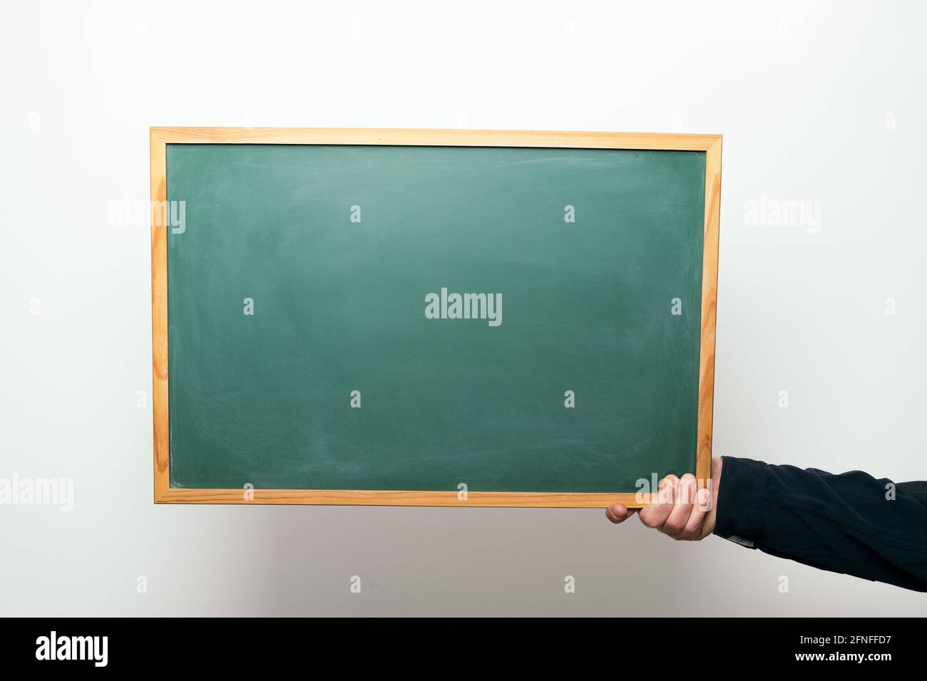 hand holding a blank blackboard, copyspace for text Stock Photo