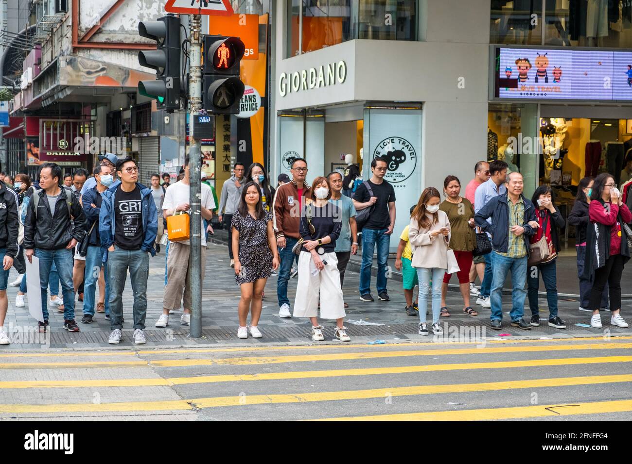 Hong Kong - November, 2019: Crowd of people waiting on traffic light to cross the street in Hong Kong Stock Photo