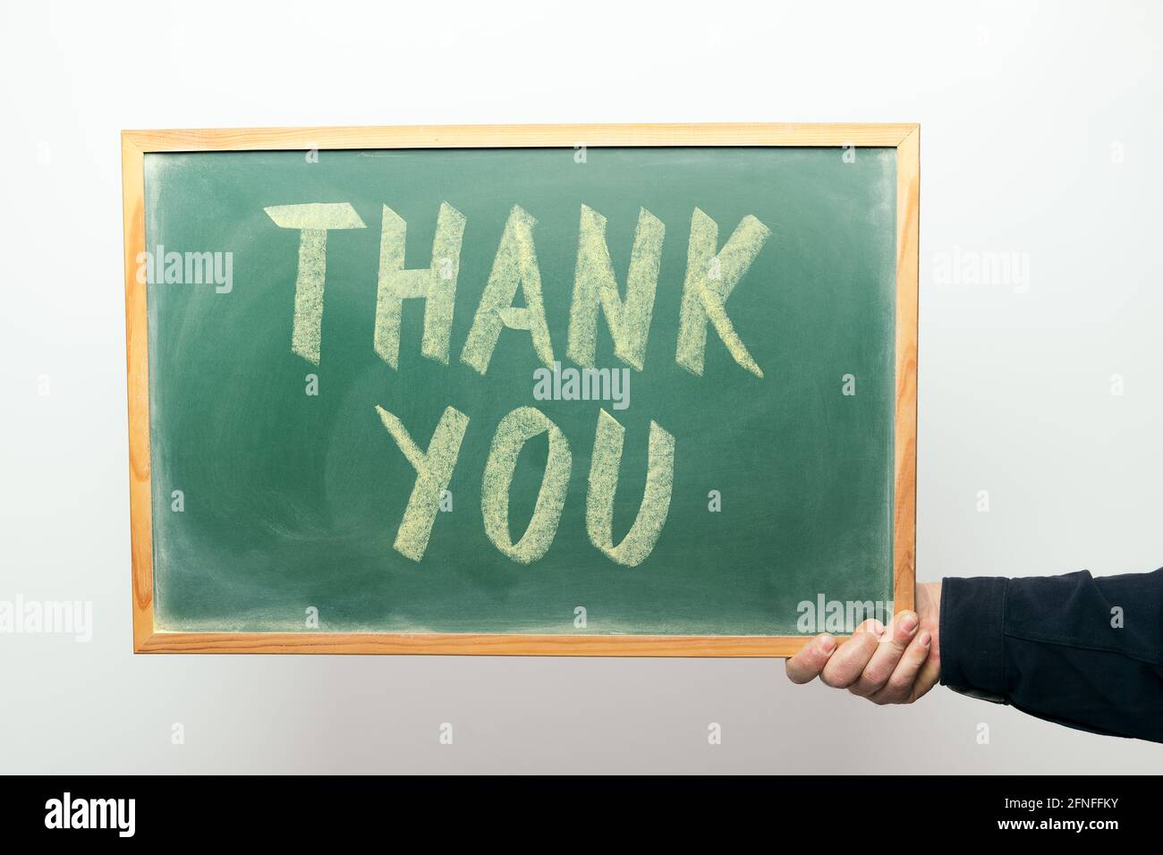 hand holding a chalkboard with the message THANK YOU handwritten in ...