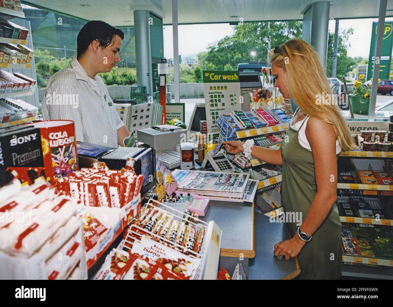 A customer paying at a gas station. [automated translation] Stock Photo