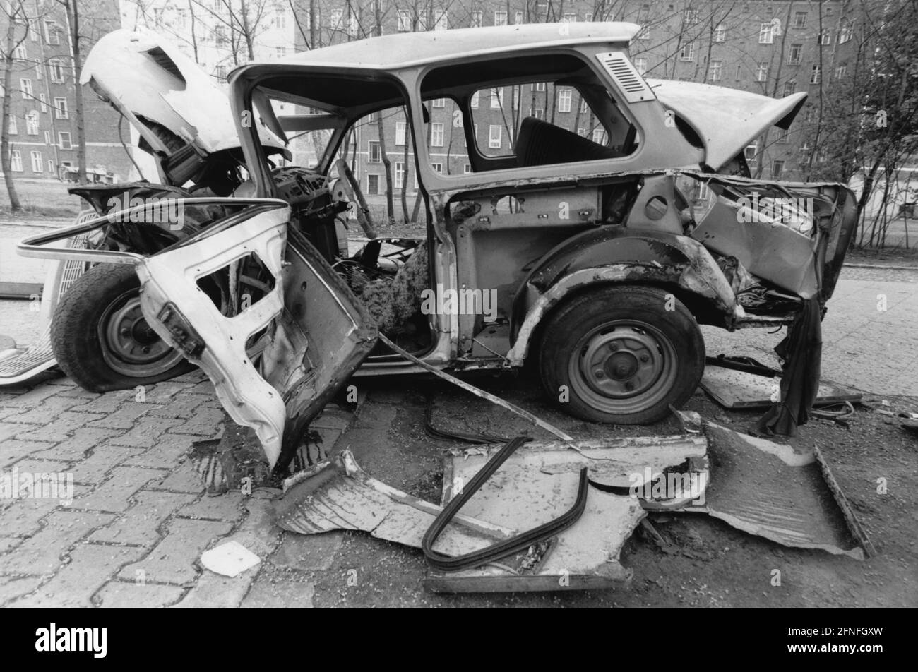 'The wreckage of a Trabant 601 sedan on Bernauer Strasse in Berlin. Due to the rapid availability of more modern vehicles, the value of the ''Trabants'' dropped rapidly after reunification. [automated translation]' Stock Photo