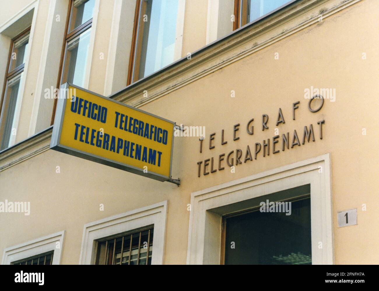 'An Italian-German sign reads ''Ufficio telegrafico'' and ''Telegraph Office''. The ''Autonomous Province of Bolzano'' is the only province in Italy to have extensive autonomy, which is expressed, for example, in the bilingualism of information and traffic signs. [automated translation]' Stock Photo