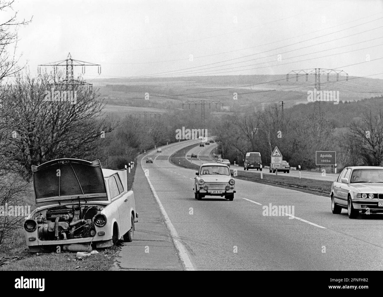 A BMW 7 series and a Trabant 601 drive past a cannibalised Trabant on the A4/E40 near Apolda. [automated translation] Stock Photo