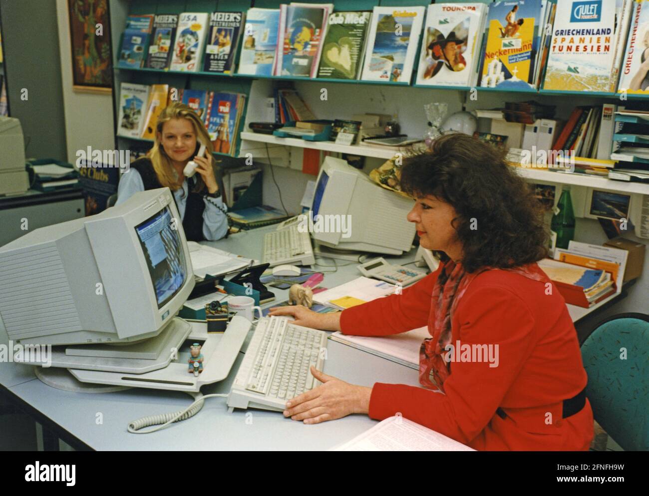 Travel agents at work. [automated translation] Stock Photo Alamy