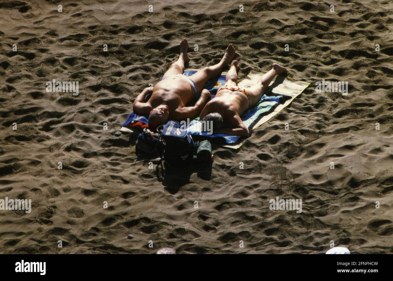 Holidaymakers sunbathe on the beach of Playa del Ingles in Gran Canaria. [automated translation] Stock Photo