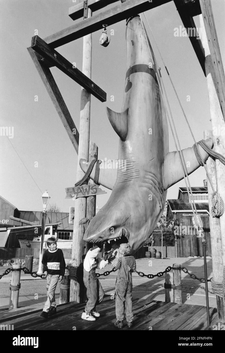 'Visitors to Universal Studios in Orlando, Florida, examine the dummy great white shark from the movie ''Jaws,'' directed by Steven Spielberg. [automated translation]' Stock Photo