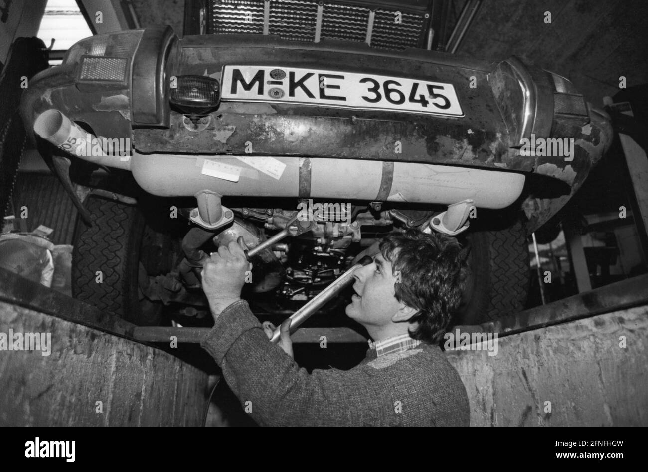 A self-employed master car mechanic of Turkish origin working on a car. [automated translation] Stock Photo