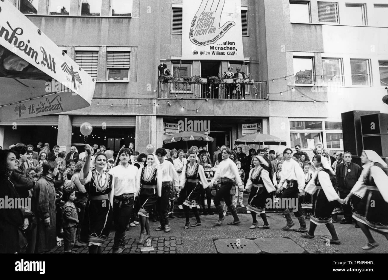 'A dance group at the DGB's ''Multicultural Friendship Festival'' in front of Haus Metall in Pionierstraße. Above the entrance is a poster reading ''Don't hit on my mate - IG Metall against xenophobia and racism''. [automated translation]' Stock Photo