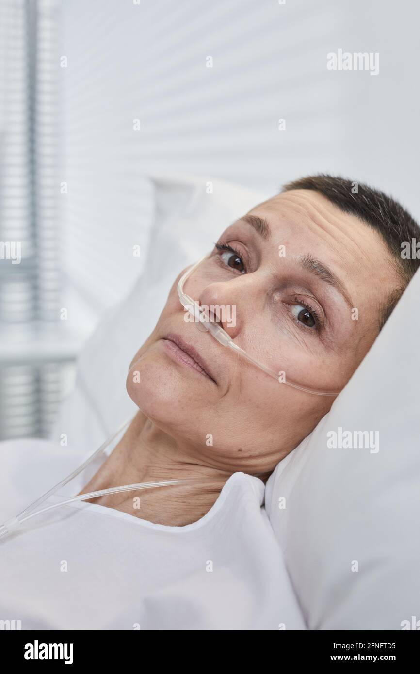 Portrait of sick mature woman lying on hospital bed Stock Photo Alamy