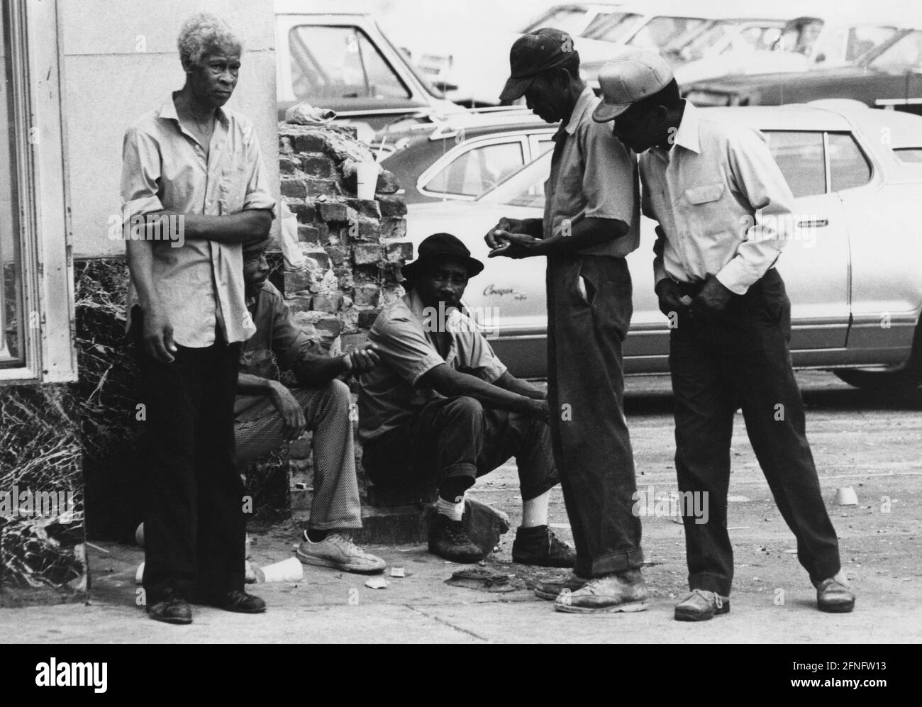 A group of African American men sit on a street corner in New Orleans. (undated photo) [automated translation] Stock Photo