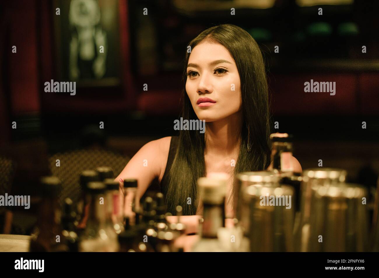 Portrait of a young beautiful Asian woman sitting in a bar Stock Photo ...