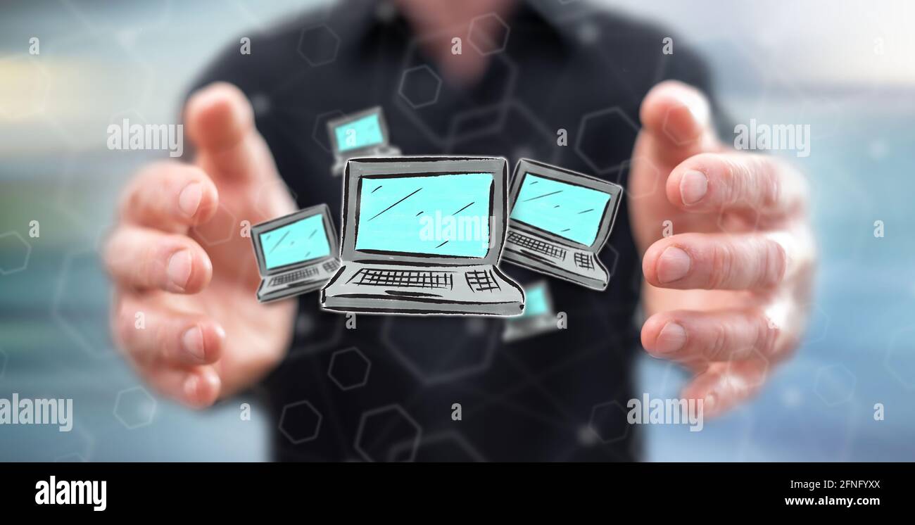 Computer concept between hands of a man in background Stock Photo - Alamy
