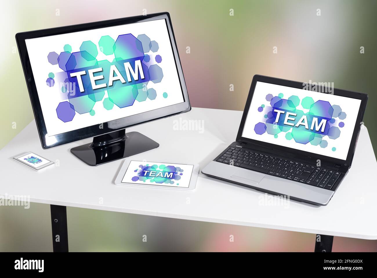 Team concept shown on different information technology devices Stock Photo