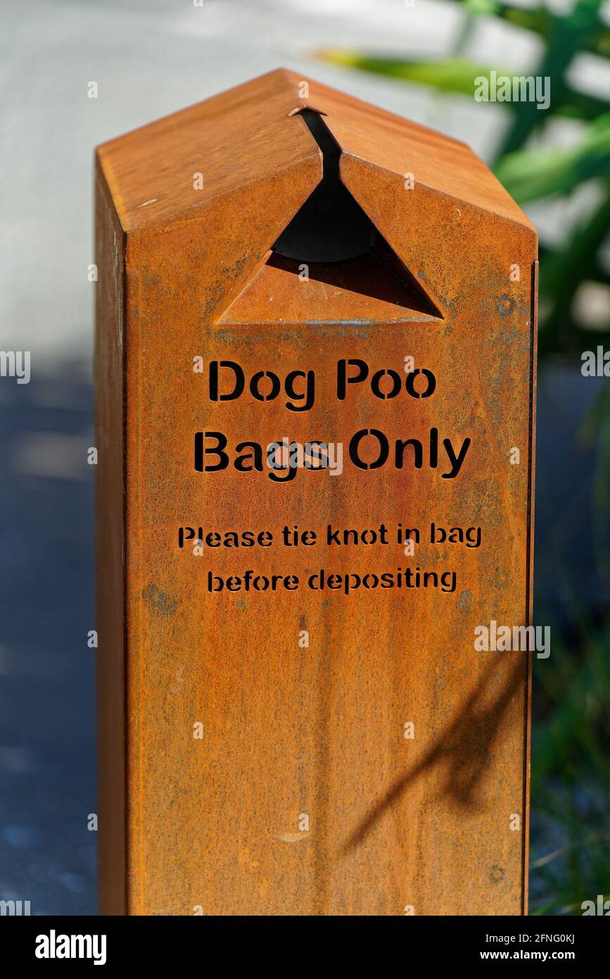 A dog poo or doggy doo disposal bin for knotted plastic bags. Stock Photo
