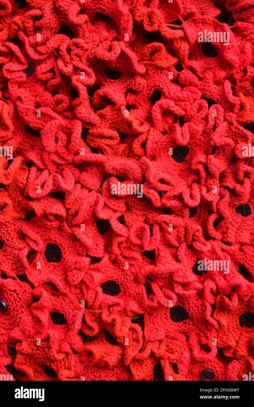crocheted poppies on war memorial, suffolk, england, uk Stock Photo