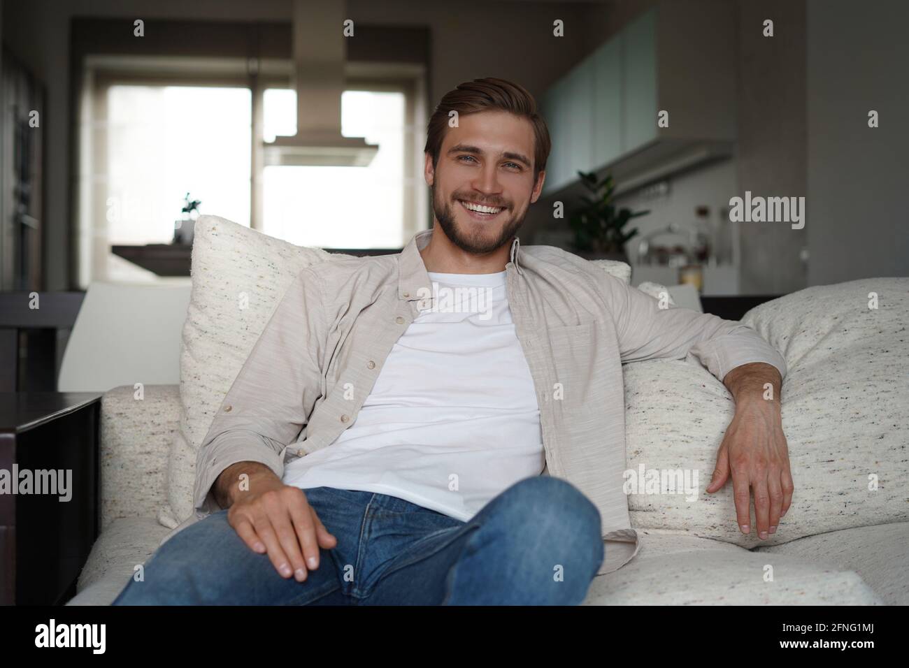 Middle-aged man having a restful moment relaxing in sofa. Stock Photo