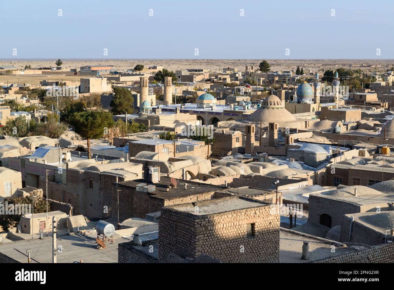 The edge of the village Mohammedieh near the town Nain and the Dasht-e Kavir desert behind that. Nain County, Isfahan Province, Iran Stock Photo